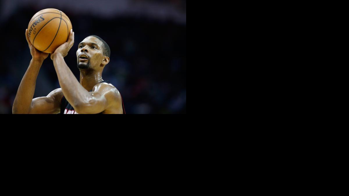 
 Chris Bosh #1 of the Miami Heat takes a free throw against the Houston Rockets during their game at the Toyota Center on January 3, 2015 in Houston, Texas. 
