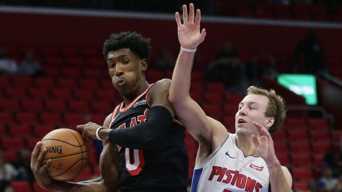 Miami Heat forward Josh Richardson (0) grabs a rebound against Detroit Pistons guard Luke Kennard (5) during the second half of an NBA basketball game Sunday, Nov. 12, 2017, in Detroit. The Pistons defeated the Heat 112-103.