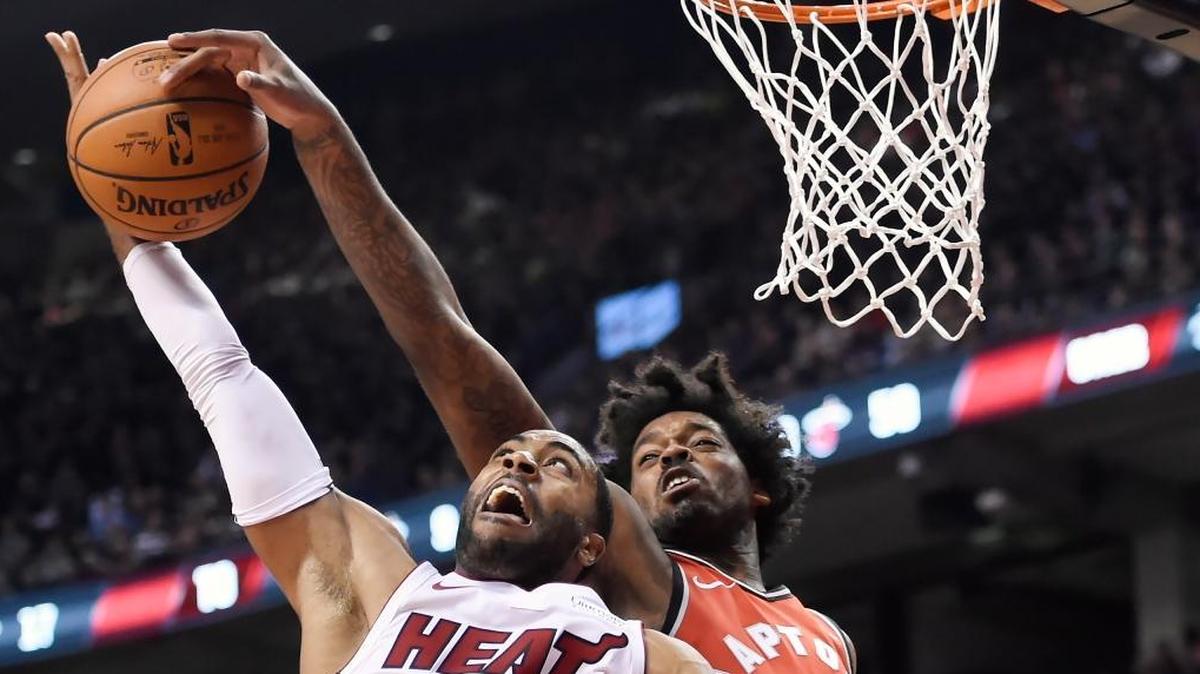 Toronto Raptors center Lucas Nogueira (92) blocks a shot from Miami Heat guard Wayne Ellington (2) during the second half of an NBA basketball game Tuesday, Jan. 9, 2018, in Toronto.