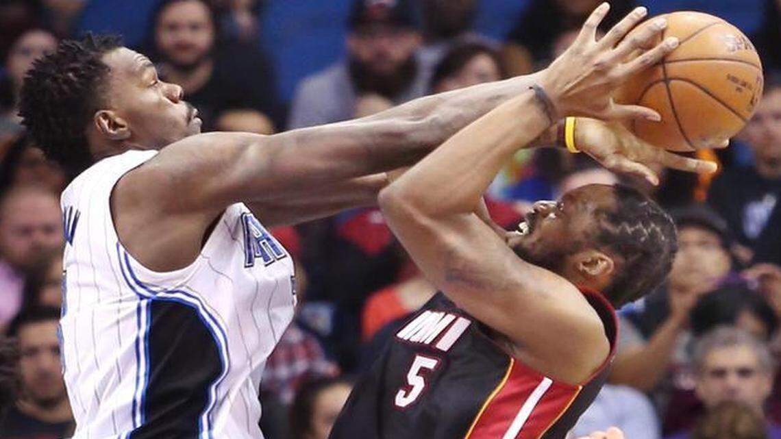 
The Miami Heat’s Henry Walker (5) is fouled by the Orlando Magic’s Dewayne Dedmon at the Amway Center in Orlando, Fla, on Wednesday, Feb. 25, 2015. 
