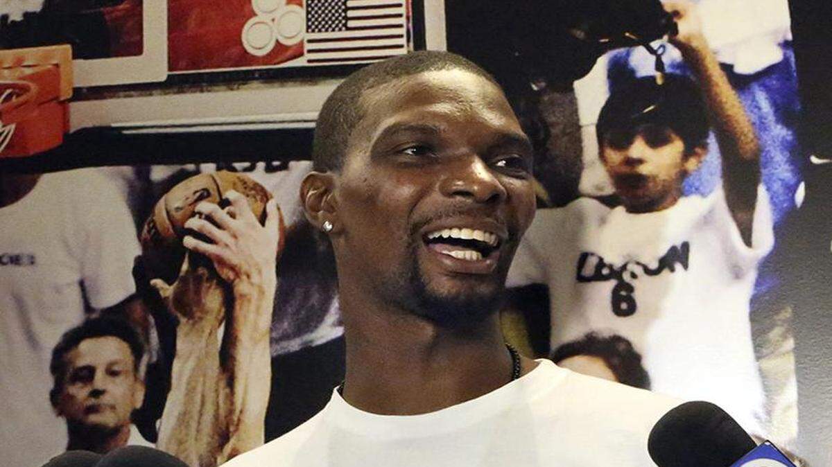 
Miami Heat forward Chris Bosh is upbeat as he talks to the media on Friday, April 17, 2015 at AmericanAirlines Arena in Miami. Players began clearing out their lockers Friday after the season came to a close.
