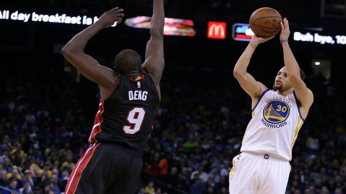 Golden State Warriors' Stephen Curry, right, shoots over Miami Heat forward Luol Deng (9) during the second half of an NBA basketball game Monday, Jan. 11, 2016, in Oakland, Calif. The Warriors won 111-103.