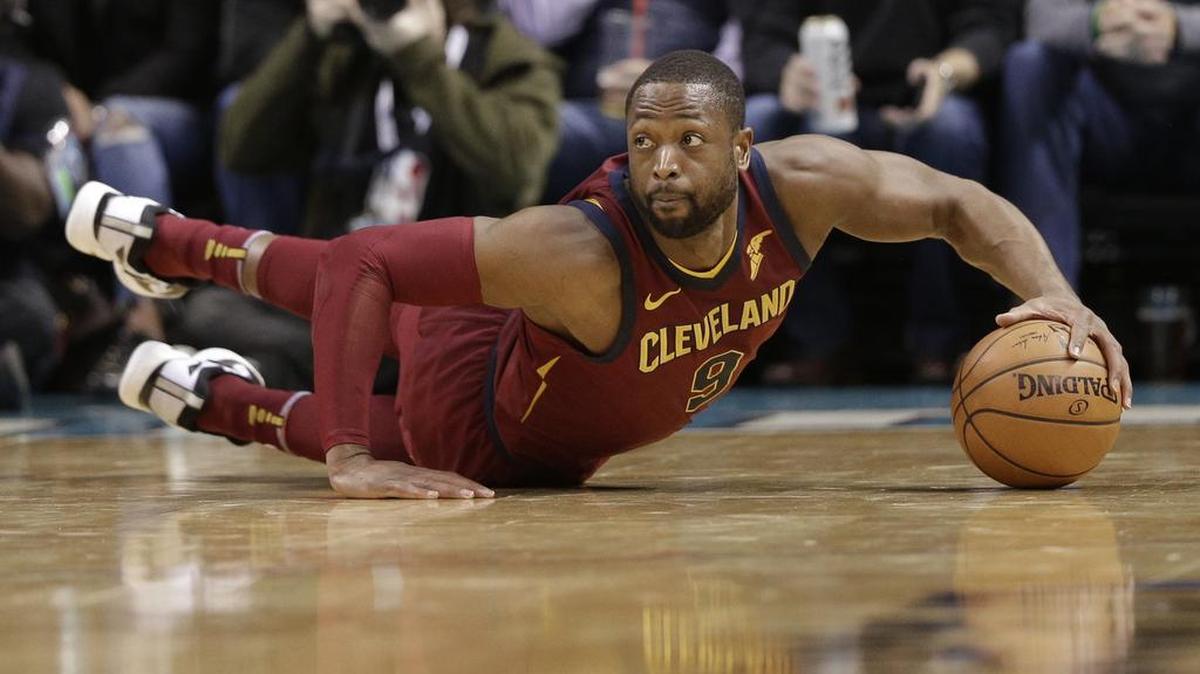Cleveland Cavaliers' Dwyane Wade chases a loose ball in the first half of an NBA basketball game against the Charlotte Hornets in Charlotte, North Carolina, on Wednesday, Nov. 15, 2017.