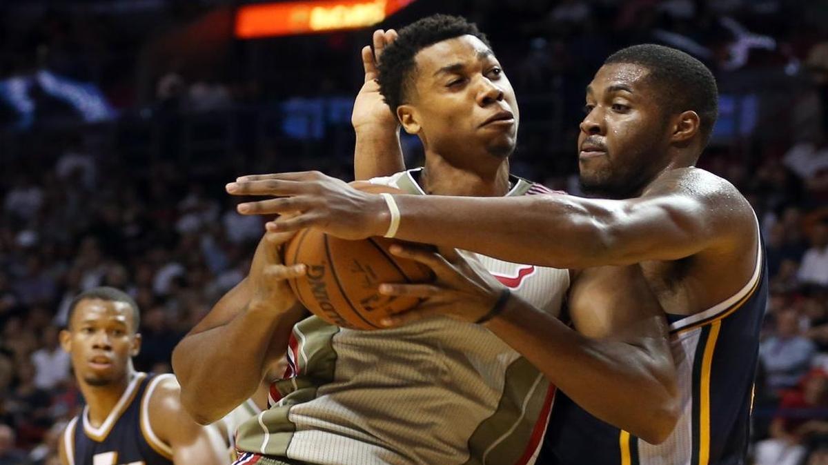 Hassan Whiteside goes to the basket against Derrick Favors in the fourth quarter of the Miami Heat’s game against the Utah Jazz at AmericanAirlines Arena in Miami on Thursday, November 12, 2015.