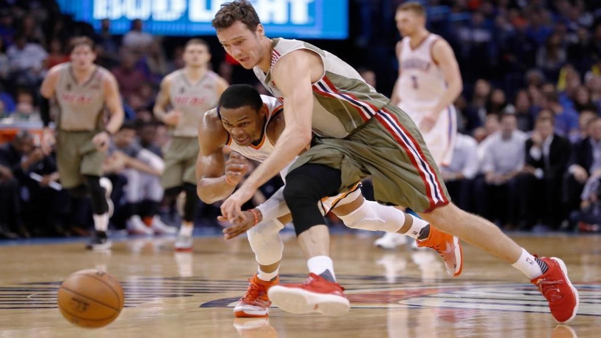 Oklahoma City Thunder guard Russell Westbrook (0) and Miami Heat guard Goran Dragic (7) dive for a loose ball during the second half of an NBA basketball game in Oklahoma City, Mon., Nov. 7, 2016. Oklahoma City won 97-85.