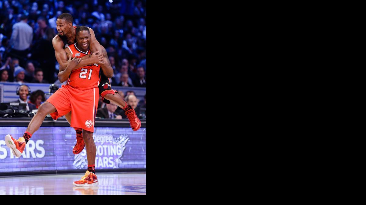 
Miami Heat's Chris Bosh, top, celebrates with Dominique Wilkins (21) after their basketball team won during the NBA All-Star Saturday Shooting Stars Contest, Saturday, Feb. 14, 2015, in New York. (AP Photo/Frank Franklin II)
