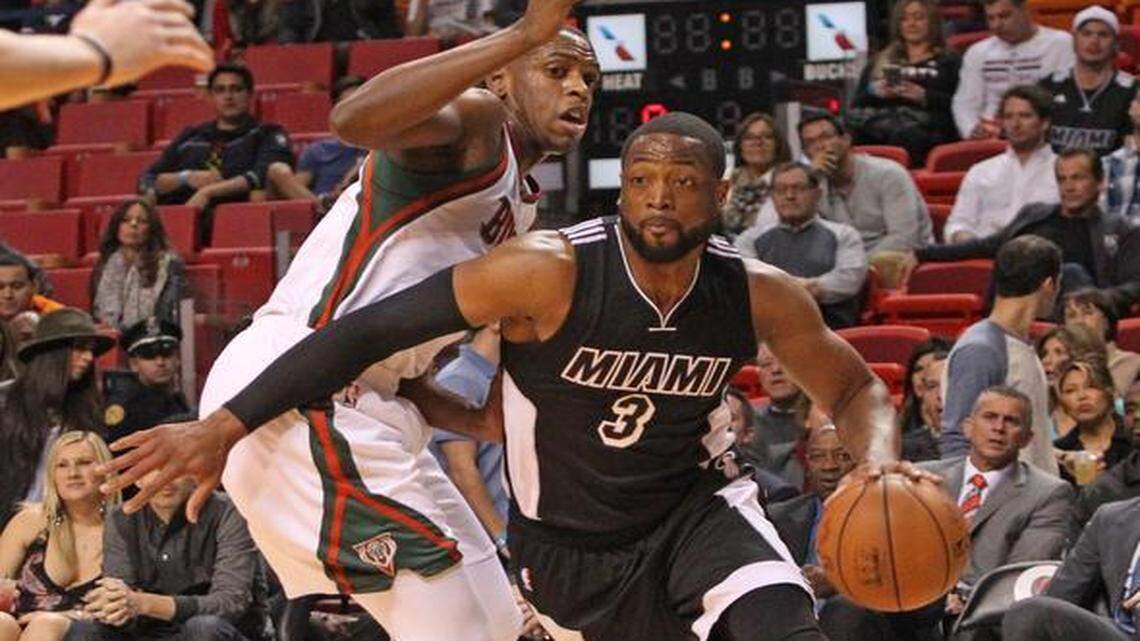 
Miami Heat guard Dwyane Wade drives past Milwaukee Bucks forward Khris Middleton in the second quarter during an NBA game at AmericanAirlines Arena on Tuesday, Jan. 27, 2015.
