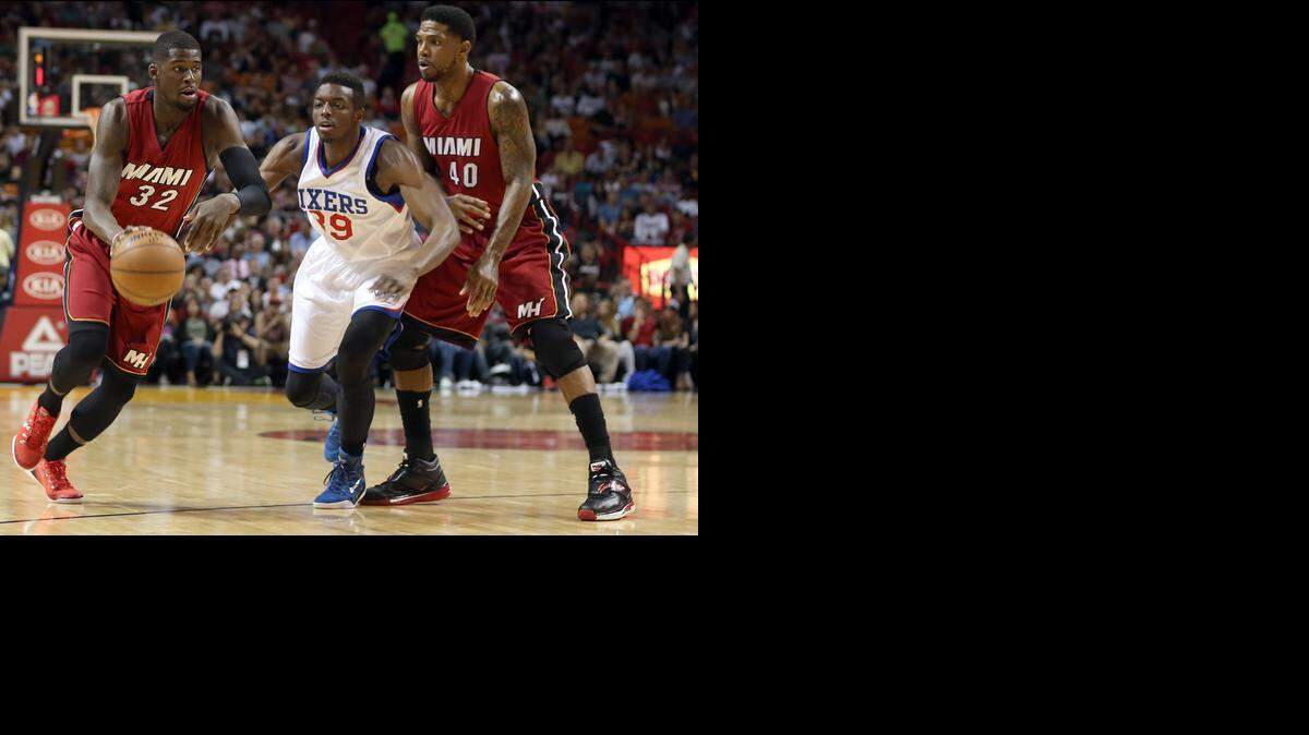 
Miami Heat forward Udonis Haslem sets a screen as James Ennis drives to the basket against Philadelphia 76ers forward Jerami Grant (39) in the first quarter of their game at AmericanAirlines Arena in Miami on Dec. 23, 2014.
