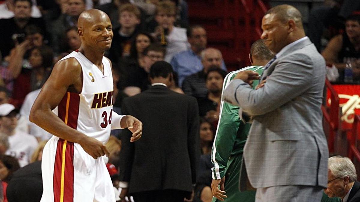 Miami Heat's Ray Allen smiles at Boston Celtics' coach Doc Rivers at the beginning of the third quarter at the AmericanAirlines Arena in Miami, Florida, Oct. 20, 2012.