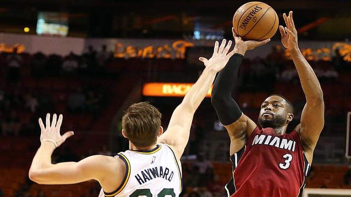 
Dwyane Wade shoots over Gordon Hayward in the fourth quarter of the Miami Heat's game against the Utah Jazz at AmericanAirlines Arena in Miami on Wednesday, Dec. 17, 2014.
