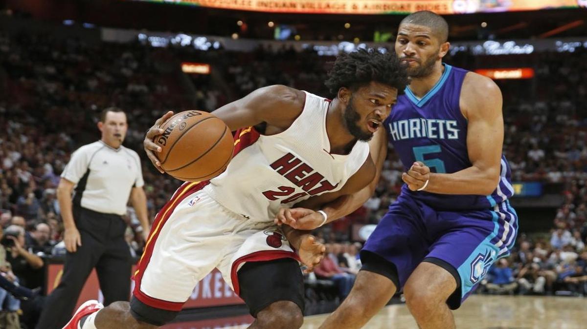 Miami Heat forward Justise Winslow (20) drives against Charlotte Hornets guard Nicolas Batum (5) in the first quarter as the Miami Heat host the Charlotte Hornets in the home opener at AmericanAirlines Arena. on Friday, October 28, 2016.