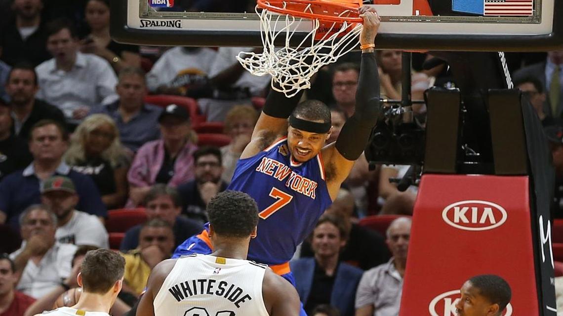 Miami Heat guard Goran Dragic, center Hassan Whiteside and guard Rodney McGruder couldn't stop Knicks' forward Carmelo Anthony from dunking in the fourth quarter of the Miami Heat and New York Knicks game at AmericanAirlines Arena in Miami on Tues., Dec. 6, 2016.