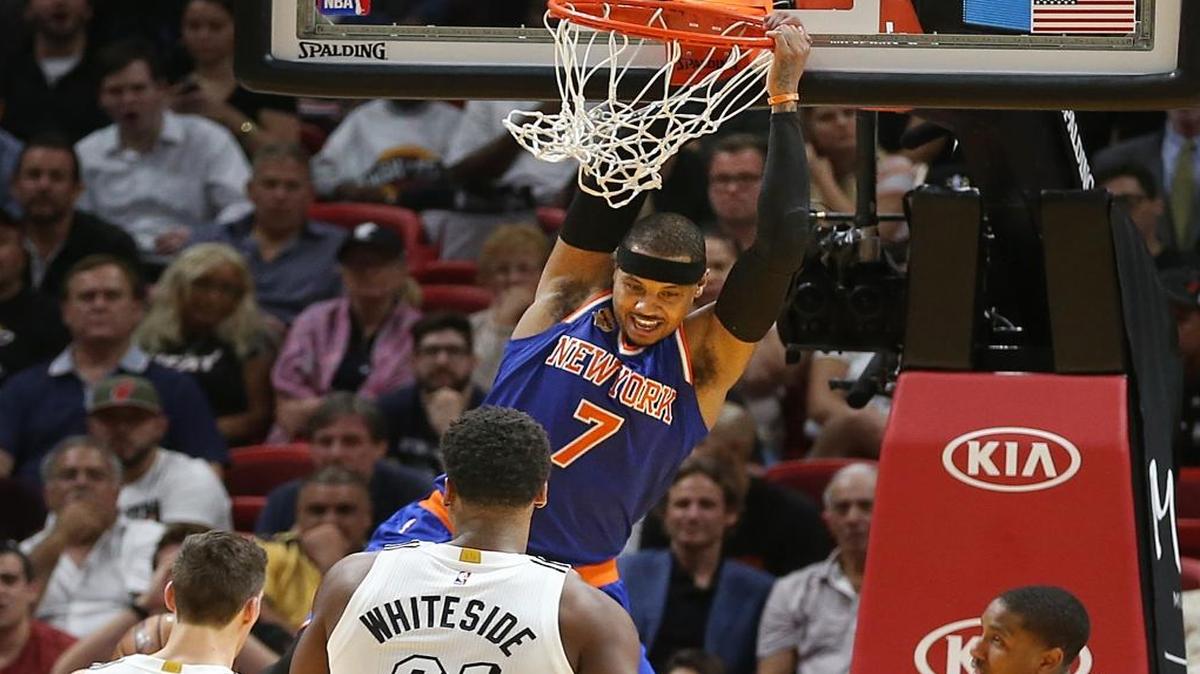 Miami Heat guard Goran Dragic, center Hassan Whiteside and guard Rodney McGruder couldn't stop Knicks' forward Carmelo Anthony from dunking in the fourth quarter of the Miami Heat and New York Knicks game at AmericanAirlines Arena in Miami on Tues., Dec. 6, 2016.
