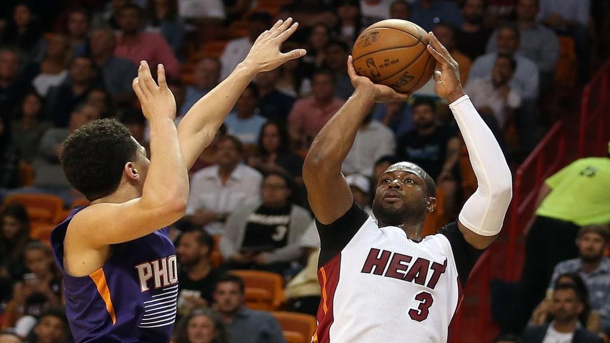 Dwyane Wade shoots over Devin Booker in the second quarter of the Miami Heat’s game against the Phoenix Suns at AmericanAirlines Arena in Miami on Thursday, March 3, 2016.