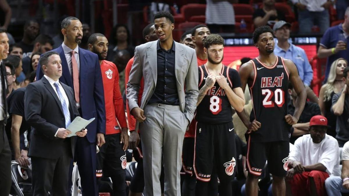Miami’s Hassan Whiteside, center, Tyler Johnson (8) and Justise Winslow (20) watch during the second half of the Heat’s game against Charlotte on Dec. 1.