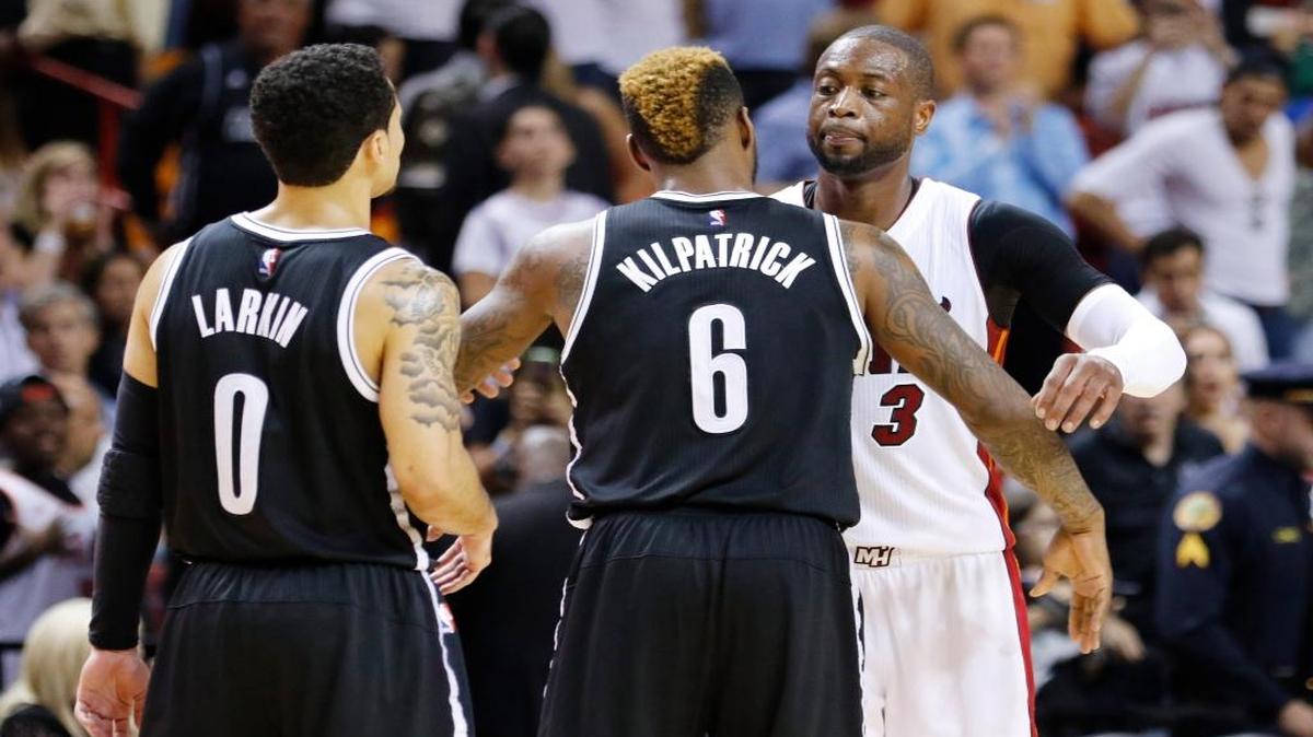 Miami Heat guard Dwyane Wade (3) greets Brooklyn Nets guard Sean Kilpatrick (6) and guard Shane Larkin (0) after the Heat defeated the Nets 110-99 in an NBA basketball game, Monday, March 28, 2016, in Miami.