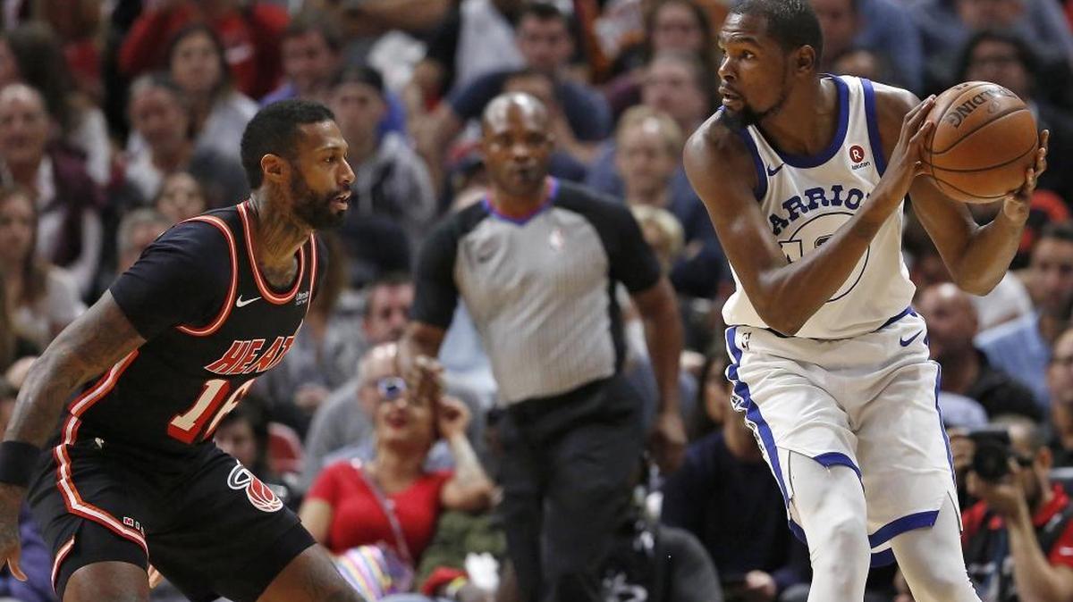 Golden State Warriors forward Kevin Durant drives against Miami Heat forward James Johnson during the first quarter at the AmericanAirlines Arena in Miami on Sunday, Dec. 3, 2017.