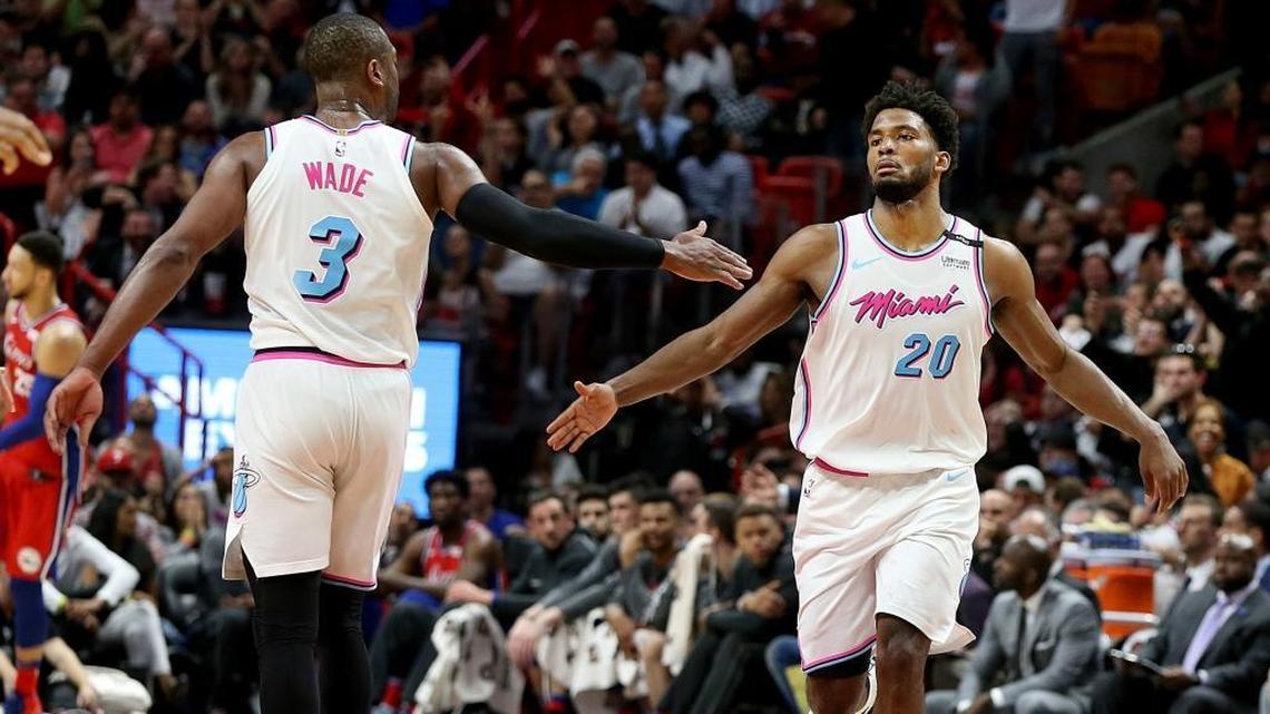 Heat guard Dwyane Wade and forward Justise Winslow celebrate as they lead the Philadelphia 76ers in the fourth quarter of a game at AmericanAirlines Arena in Miami on Thursday, March 08, 2018.