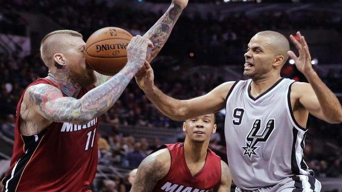 
Miami Heat’s Chris Andersen (11) takes a ball to the face as San Antonio Spurs guard Tony Parker (9) loses control of the ball during the second half Friday, Feb. 6, 2015, in San Antonio. San Antonio won 98-85. 
