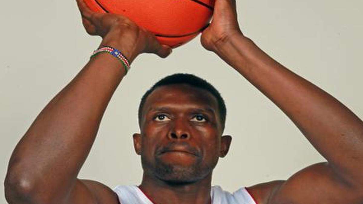 
Miami Heat newcomer Luol Deng poses for photos during Media Day at AmericanAirlines Arena in Miami, Florida, Sept. 26, 2014.
