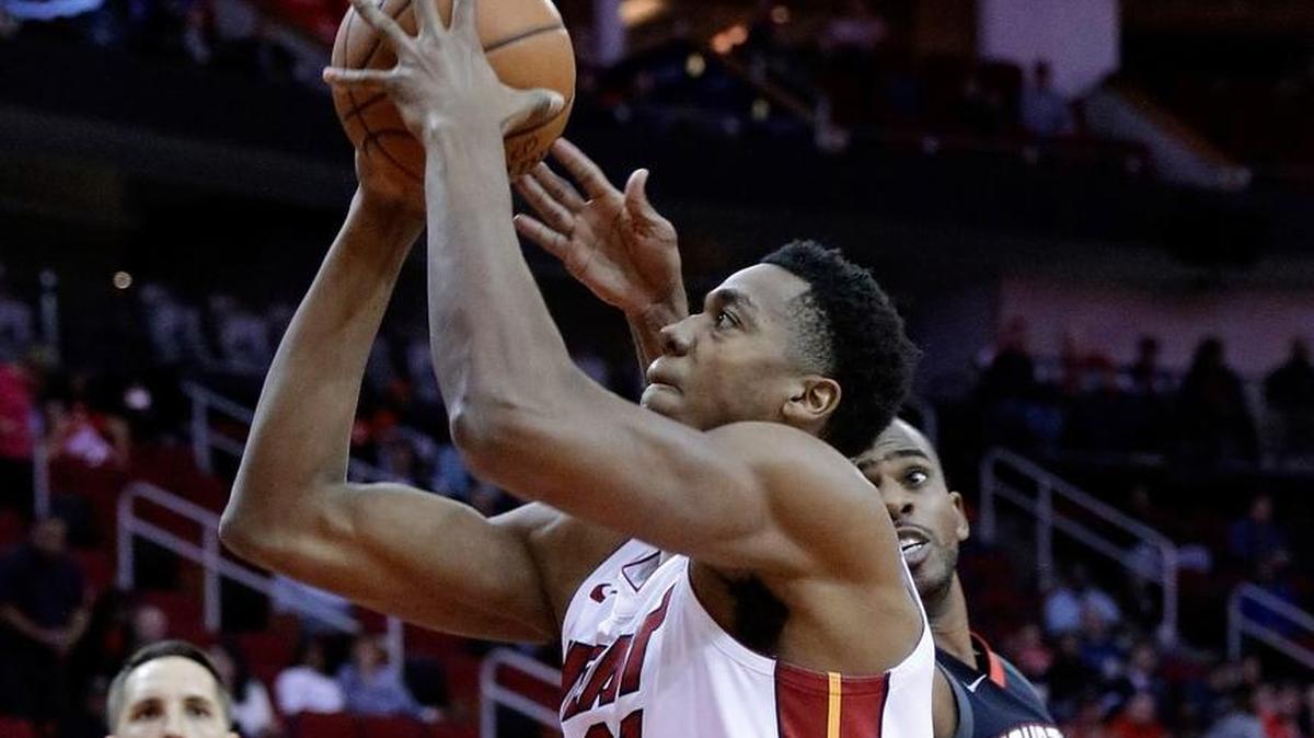 Miami Heat center Hassan Whiteside shoots past Houston Rockets guard Chris Paul during the first half Monday, Jan. 22, 2018, in Houston.