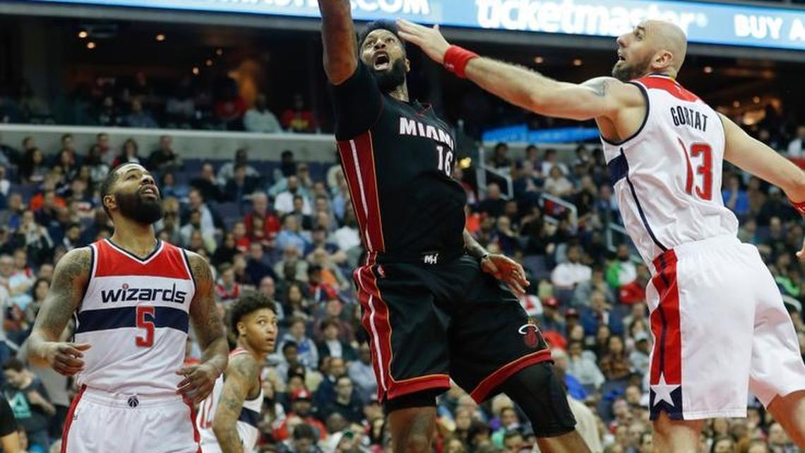Miami Heat forward James Johnson (16) scores past Washington Wizards Markieff Morris (5) and Marcin Gortat (13) during the second half of an NBA basketball game in Washington, Saturday, April 8, 2017. Miami defeated Washington 106-103.