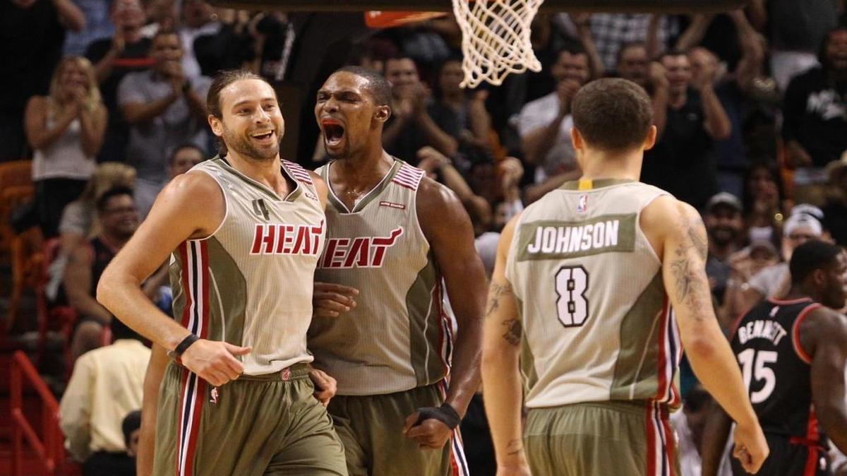 Chris Bosh and Josh McRoberts of the Miami Heat celebrate in the fourth quarter during a game against the Toronto Raptors on Sunday, November 8, 2015 at AmericanAirlines Arena.