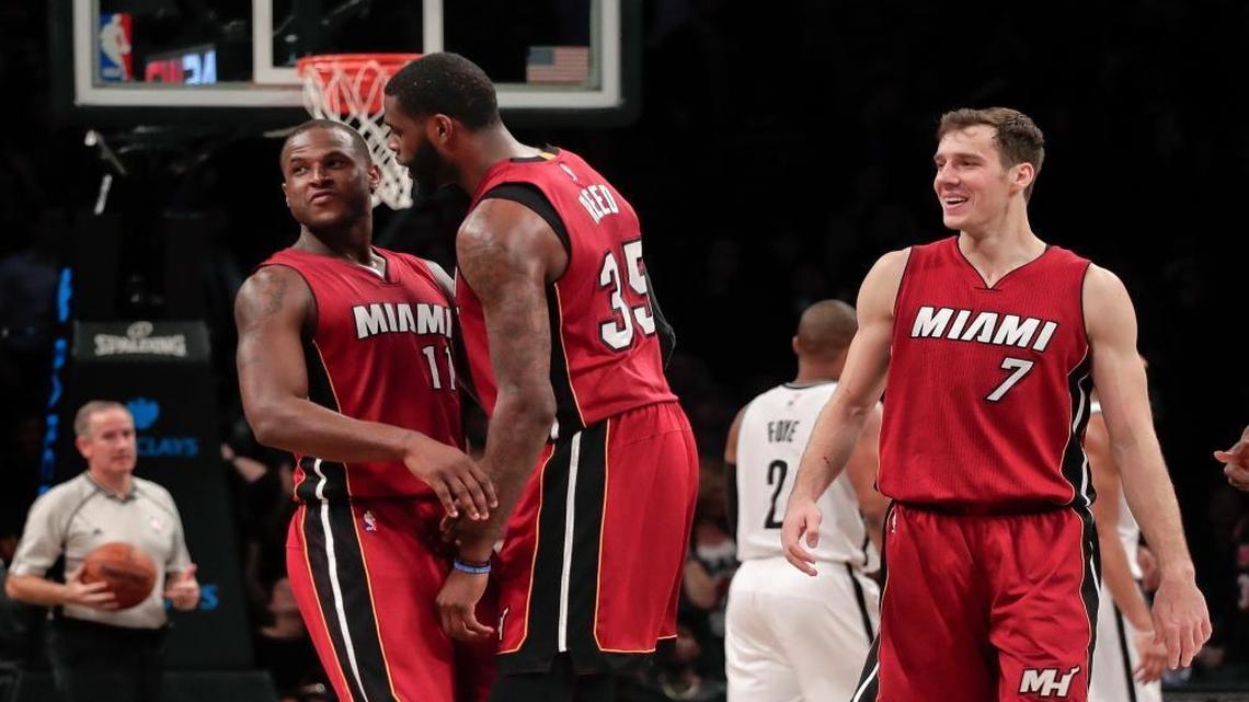 Miami Heat guard Dion Waiters (11) is congratulated by forward Willie Reed (35) and guard Goran Dragic (7) after hitting a 3-point shot against the Brooklyn Nets with seconds left in an NBA basketball game, Wed., Jan. 25, 2017, in New York. The Heat won 109-106.