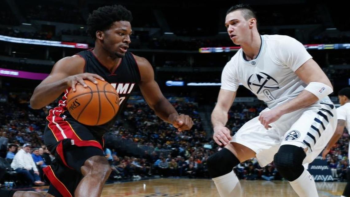 Miami Heat forward Justise Winslow, left, drives against Denver Nuggets forward Danilo Gallinari during the first half Friday, Jan. 15, 2016, in Denver.