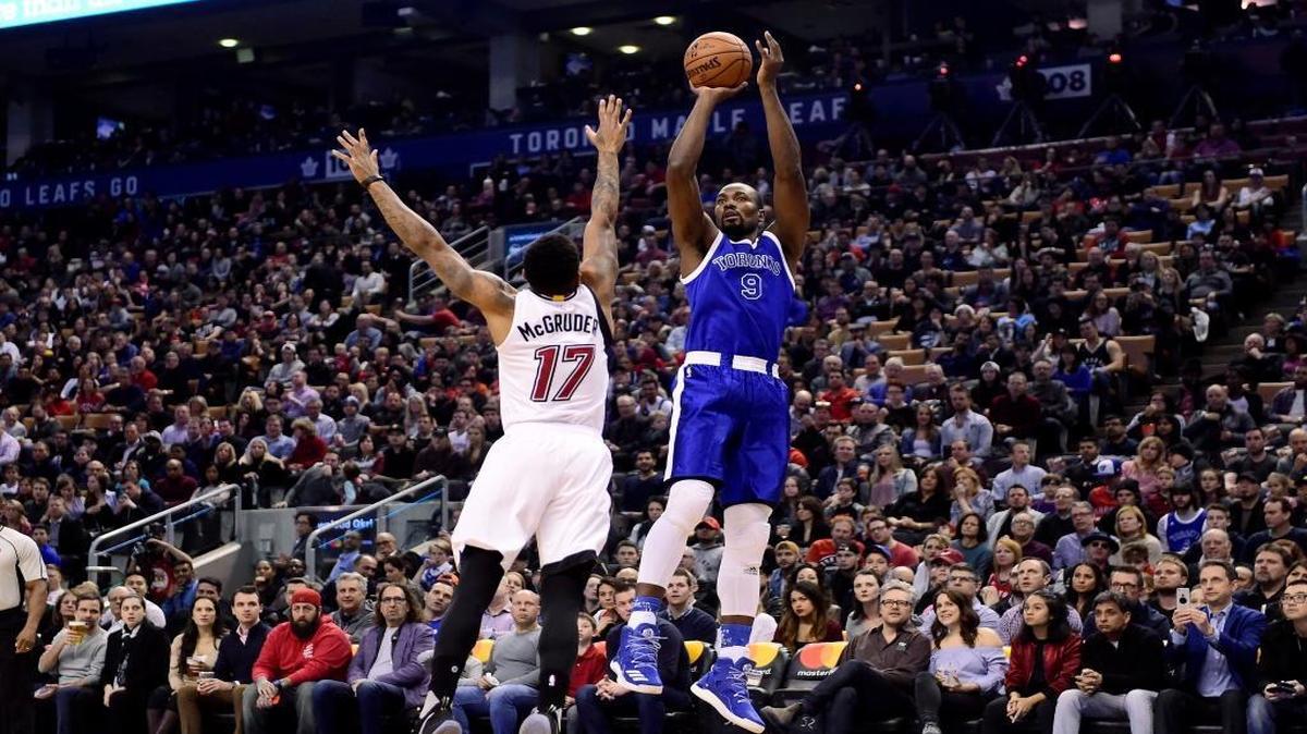 Toronto Raptors forward Serge Ibaka shoots as Miami Heat guard Rodney McGruder defends during the first half of an NBA basketball game Friday, April 7, 2017, in Toronto.