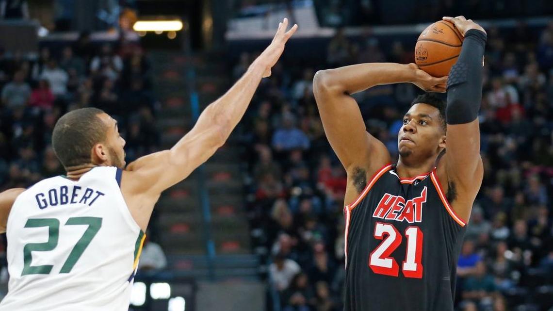 Miami Heat center Hassan Whiteside (21) shoots as Utah Jazz center Rudy Gobert (27) defends in the first half during an NBA basketball game Friday, Nov. 10, 2017, in Salt Lake City.