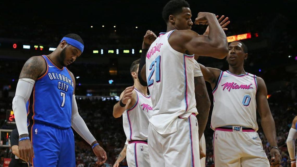 Oklahoma City Thunder forward Carmelo Anthony looks on as Miami Heat center Hassan Whiteside reacts after scoring during the first quarter of an April 9 game. The Heat has met with Anthony in recent days in anticipation of his parting with the Oklahoma City Thunder.