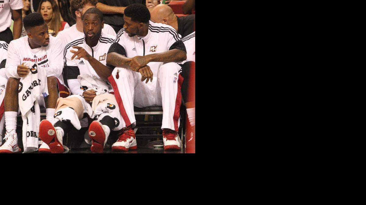 
Norris Cole, Dwyane Wade and Udonis Haslem sit on the bench during the Miami Heat's preseason game against the Orlando Magic at AmericanAirlines Arena in Miami on Tuesday, Oct. 7, 2014.
