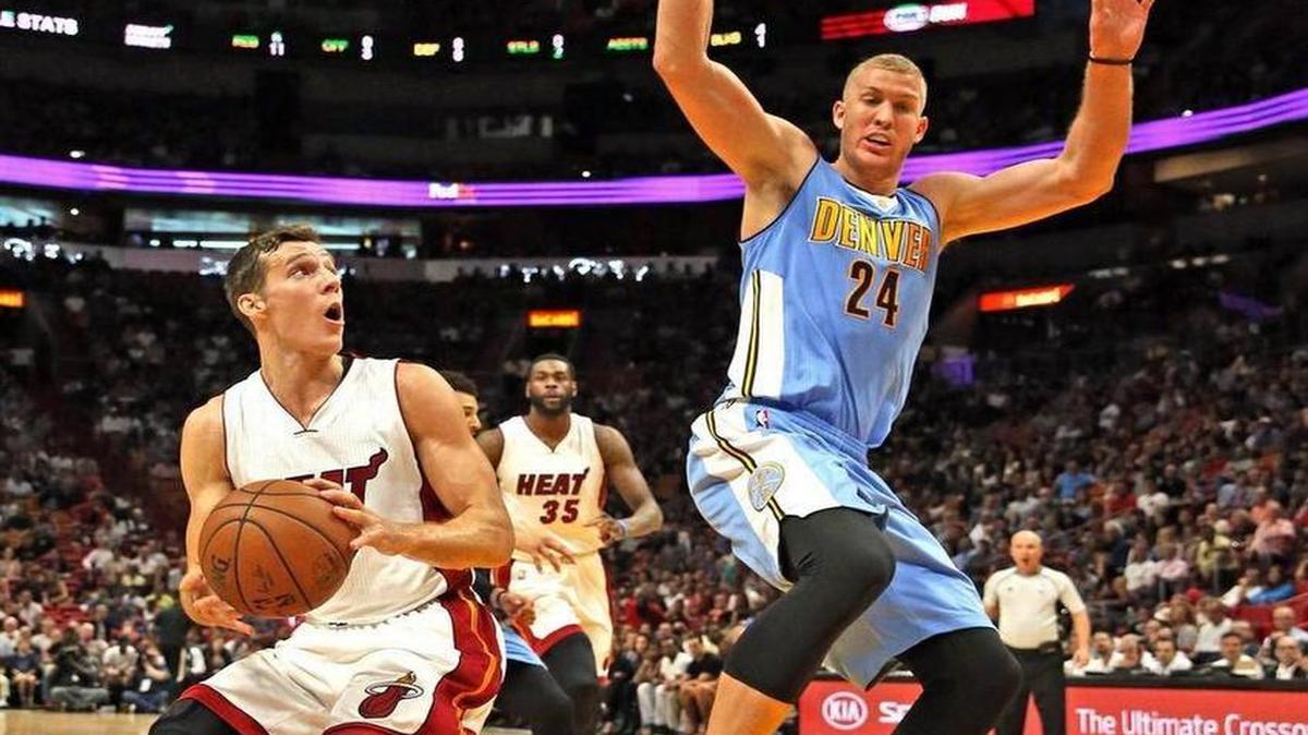 Miami Heat Goran Dragic looks to the basket as Denver Nuggets Mason Plumlee defends in the second quarter at the AmericanAirlines Arena, Miami, Florida, April 2, 2017.