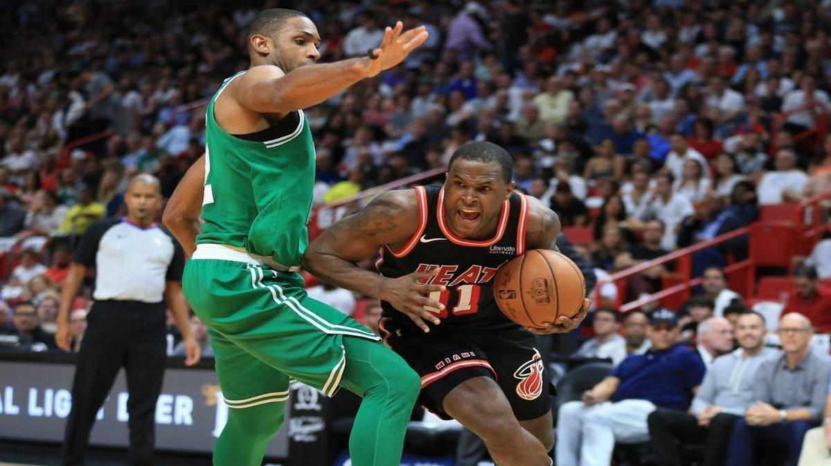 Miami Heat guard Dion Waiters (11) drives the ball around Boston Celtics forward Al Horford (42) in a game in November.