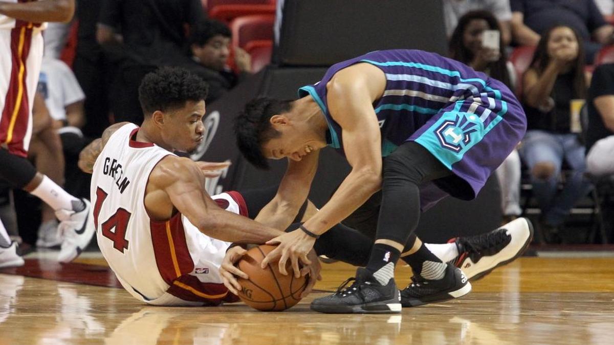 
Miami Heat forward Gerald Green fights Charlotte Hornets guard Jeremy Lin for a loose ball in the second quarter of both teams’ first preseason game at the AmericanAirlines Arena in Miami on Oct. 4, 2015.
