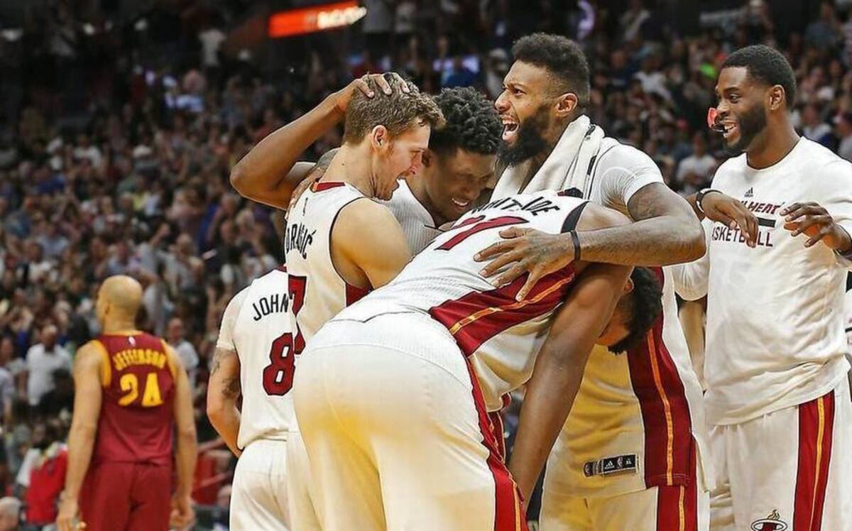 Miami Heat guard Goran Dragic celebrates and huddles with teammates James Johnson, Hassan Whiteside, Richardson and Willie Reed as the Heat beats the Cleveland Cavaliers on April 10, 2017.