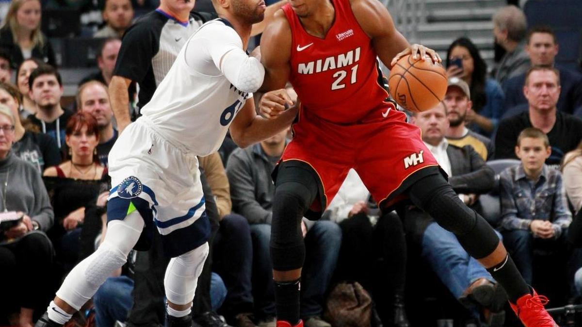 Miami Heat center Hassan Whiteside (21) dribbles against Minnesota Timberwolves center Taj Gibson (67) in the first quarter of an NBA basketball game on Friday, Nov. 24, 2017, in Minneapolis.
