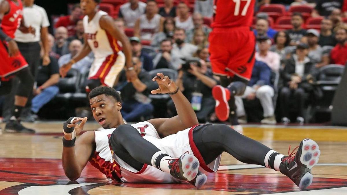Miami Heat Hassan Whiteside lays on the court after being knocked over in the first quarter as they play the Toronto Raptors at the AmericanAirline Arena in Miami, Florida, March 23, 2017.