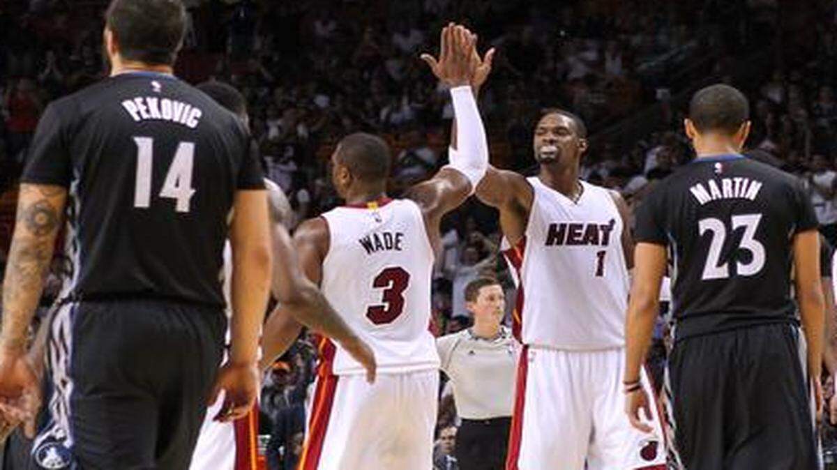 
Miami Heat guard Dwyane Wade is congratulated by his teammates after play against the Minnesota Timberwolves during the foruth quarter of an NBA basketball game at the AmericanAirlines Arena in Miami on Saturday, November 8, 2014.

