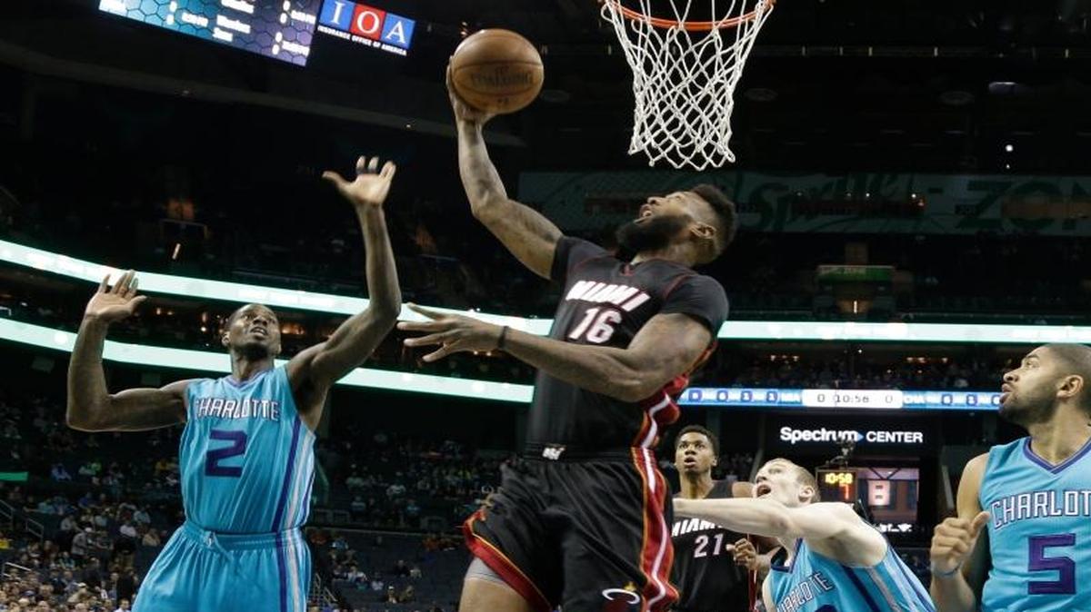 Miami Heat forward James Johnson (16) shoots as Charlotte Hornets’s Marvin Williams (2), Cody Zeller (40), and Nicolas Batum (5) defend in the first half of an NBA basketball game in Charlotte, N.C., Wednesday, April 5, 2017.