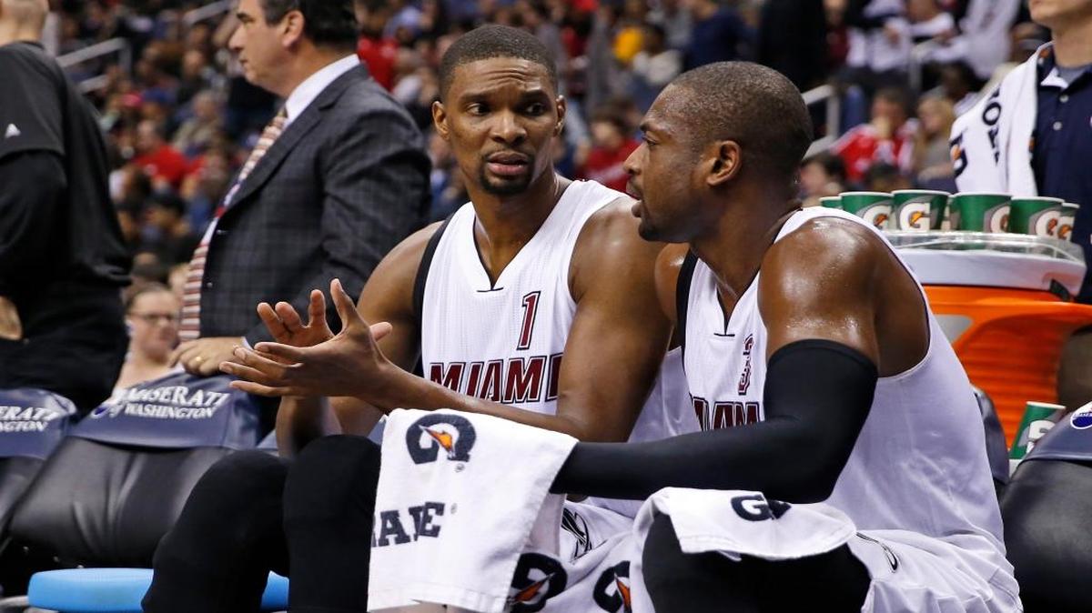 Miami Heat forward Chris Bosh (1) and Miami Heat guard Dwyane Wade (3) talk as they sit on the bench during a break in the second half of an NBA basketball game against the Washington Wizards, Sunday, Jan. 3, 2016, in Washington. The Heat won 97-75.