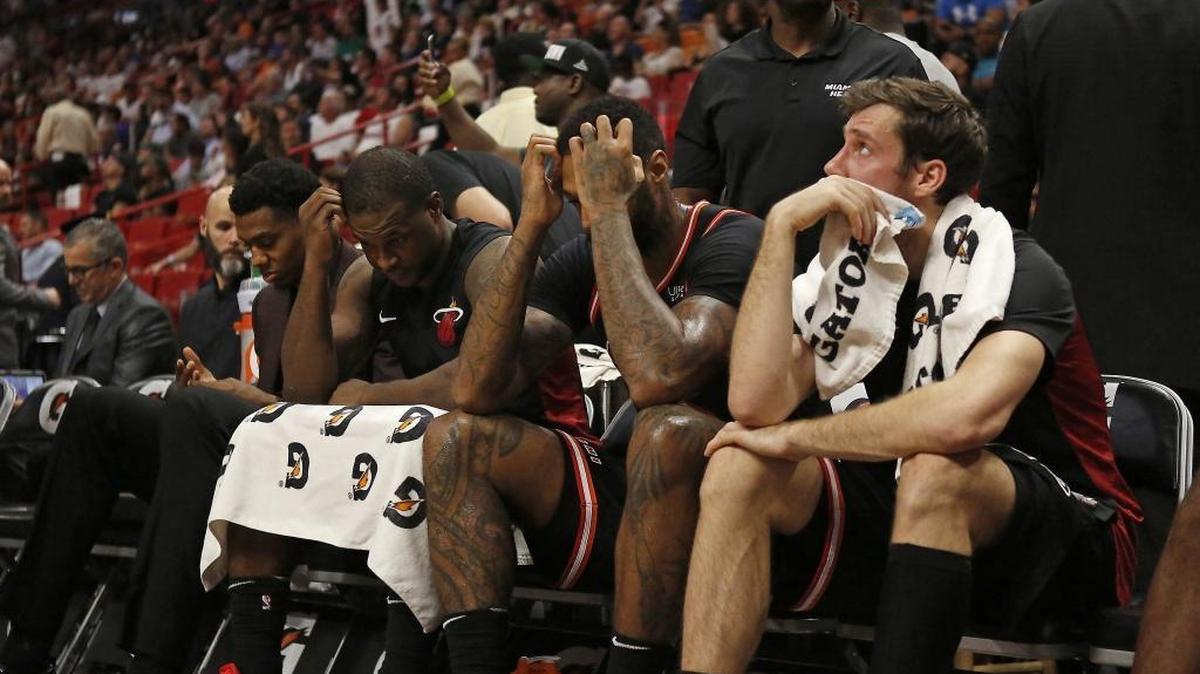Miami Heat players, from left, Hassan Whiteside, Dion Waiters, James Johnson and Goran Dragic, looking from the bench during the fourth quarter of an NBA basketball game against the Golden State Warriors at the AmericanAirlines Arena in Miami on Sunday, Dec. 3, 2017.