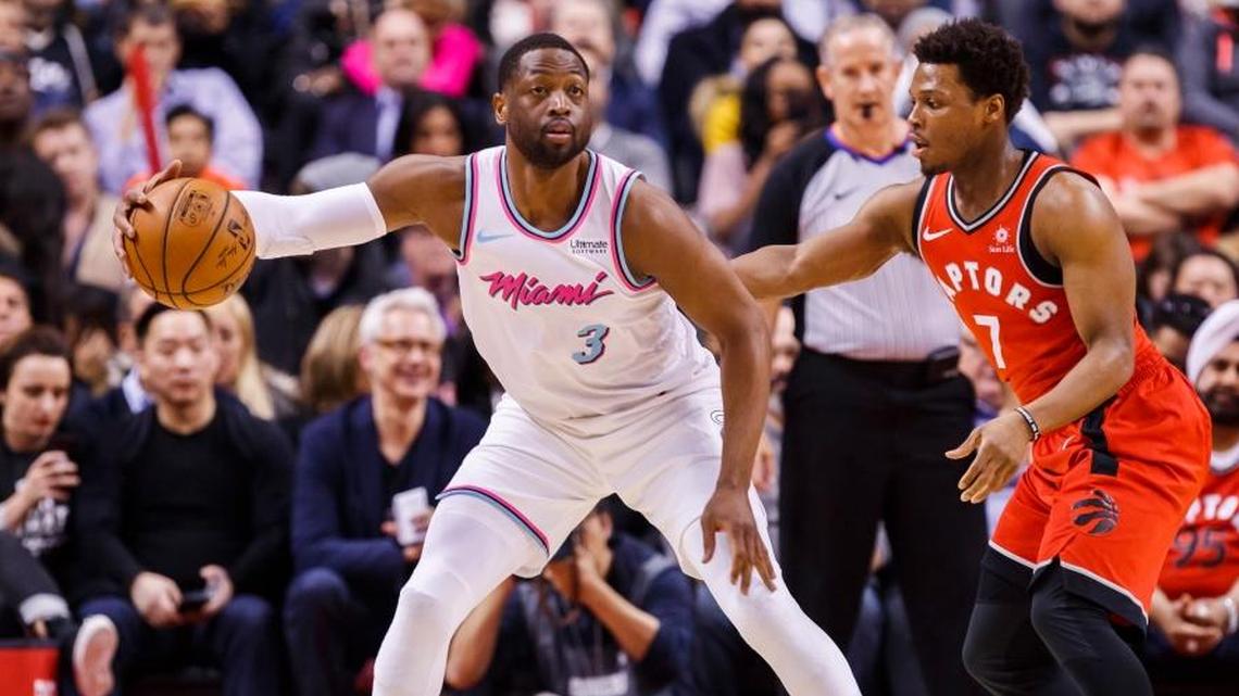 Miami Heat guard Dwyane Wade is guarded by Toronto Raptors' guard Kyle Lowry, right, during Tuesday’s Heat loss. (Mark Blinch/The Canadian Press via AP)
