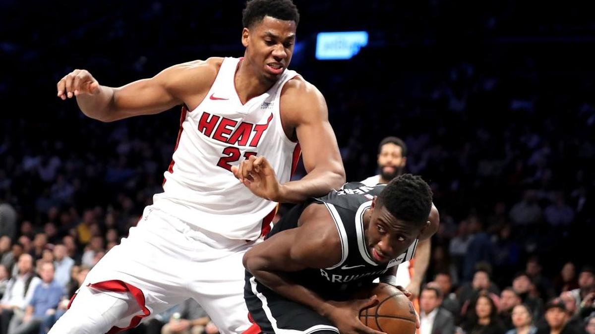 Caris LeVert (No. 22) of the Brooklyn Nets works against Hassan Whiteside (No. 21) of the Miami Heat in the third quarter during their game Jan. 19, 2018, in Brooklyn. Whiteside scored 22, grabbed 13 rebounds and blocked four shots during the Heat’s 101-95 loss to the Nets.