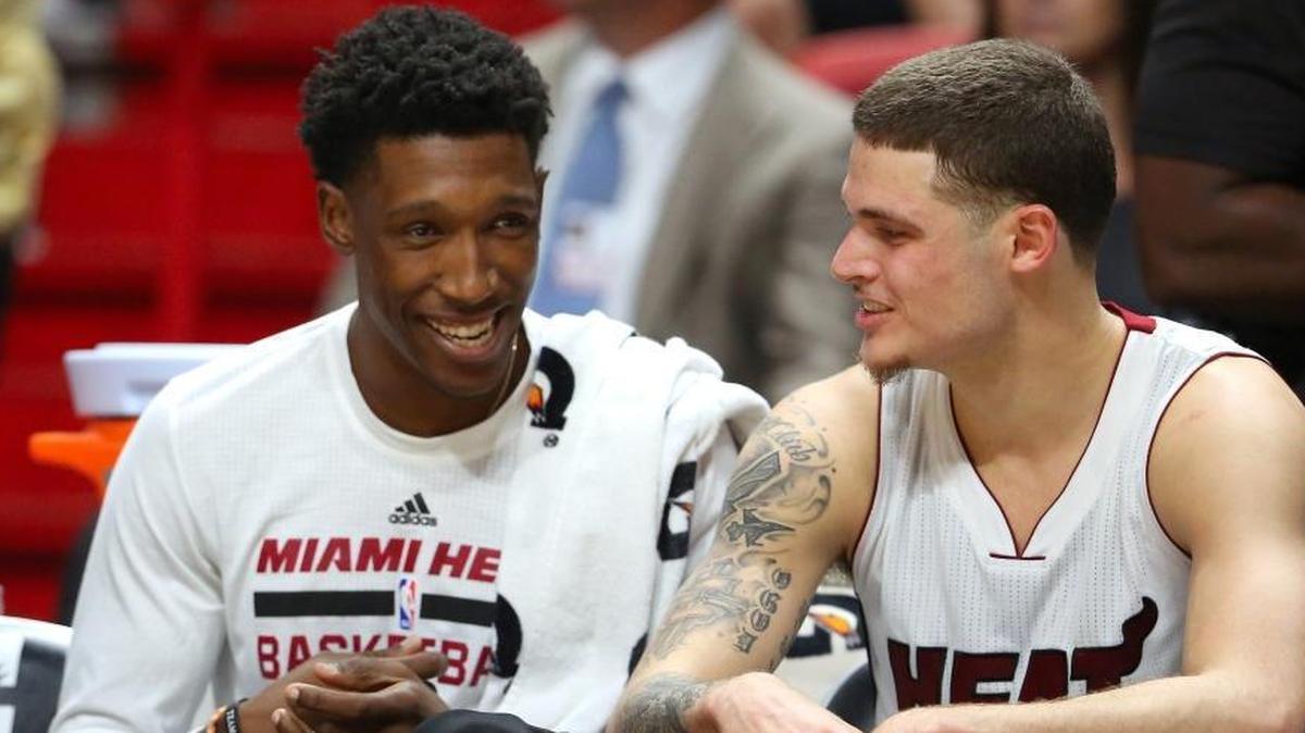 Miami Heat guard Josh Richardson, left, and teammate guard Tyler Johnson talk in the fourth quarter of a preseason NBA basketball game against the Orlando Magic at the AmericanAirlines Arena on Tuesday, Oct. 18, 2016, in Miami.