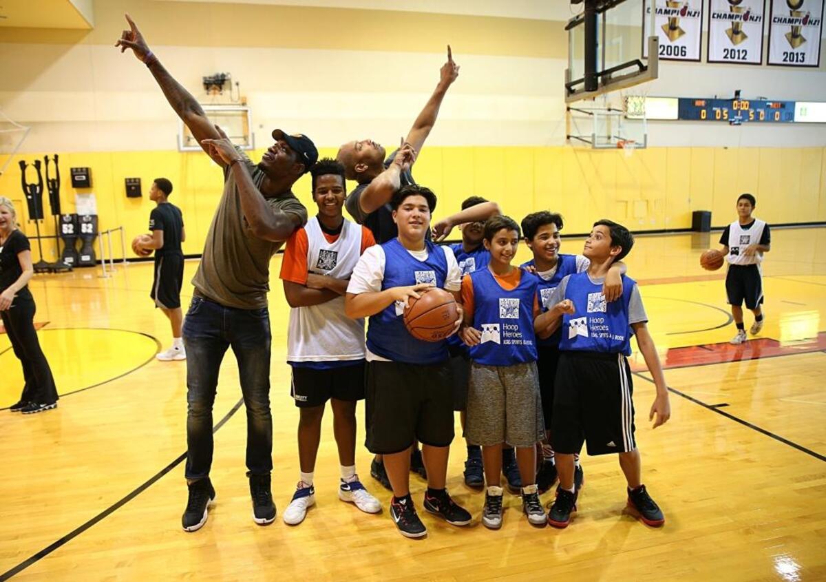 Kids from across South Florida pose with NBA free agent Lester Prosper, far left, and former Miami Heat player Mark Strickland during Camp Hoop Heroes at AmericanAirlines Arena in Miami on Wednesday, July 19, 2017.