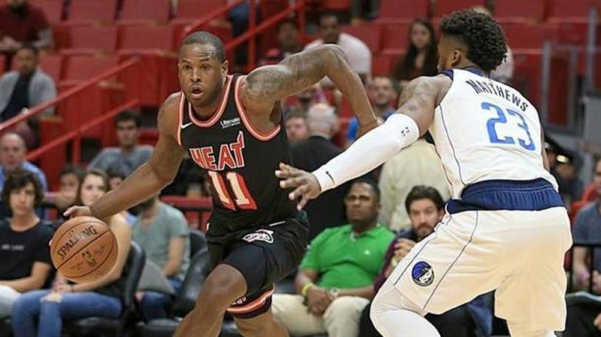 Heat guard Dion Waiters drives to the basket against Mavericks' guard Wesley Matthews in the first quarter of a game at AmericanAirlines Arena on Friday, December 22, 2017.