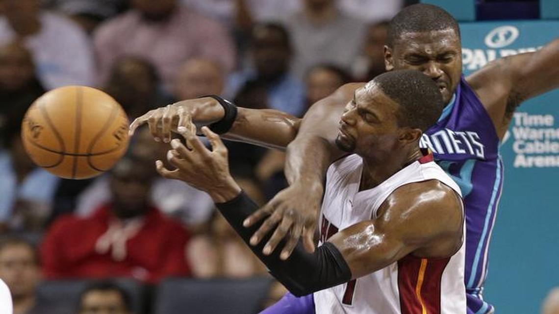 
Miami Heat's Chris Bosh, front, is fouled by Charlotte Hornets' Jason Maxiell during the first half of an NBA basketball game in Charlotte, N.C., Wednesday, Nov. 5, 2014. 
