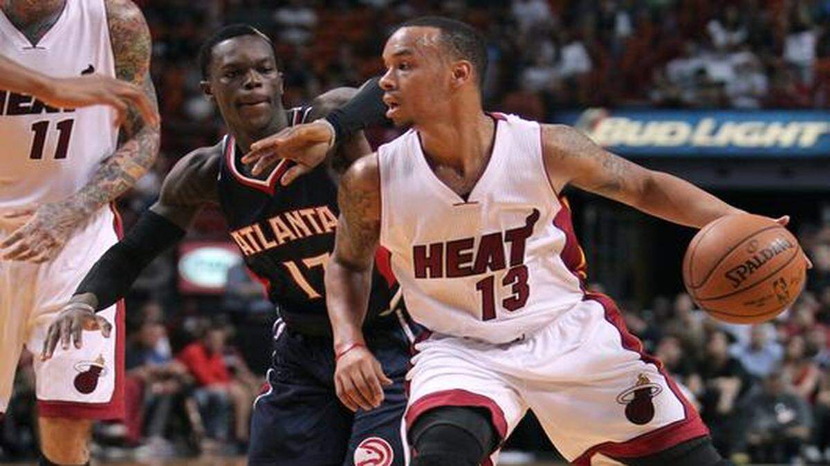 
Miami Heat guard Shabazz Napier drives against Atlanta Hawks guard Dennis Schroder during the fourth quarter of a preseason NBA game at the AmericanAirlines Arena in Miami on Tuesday, October 14, 2014.
